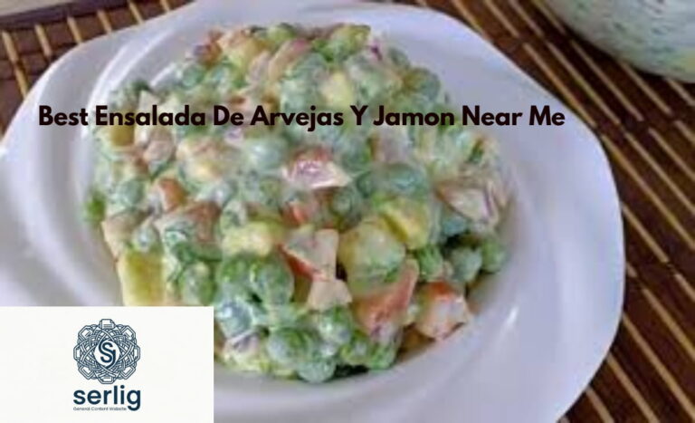 Best ensalada de arvejas y jamon in a white bowl with green peas, diced ham, eggs, and parsley garnish