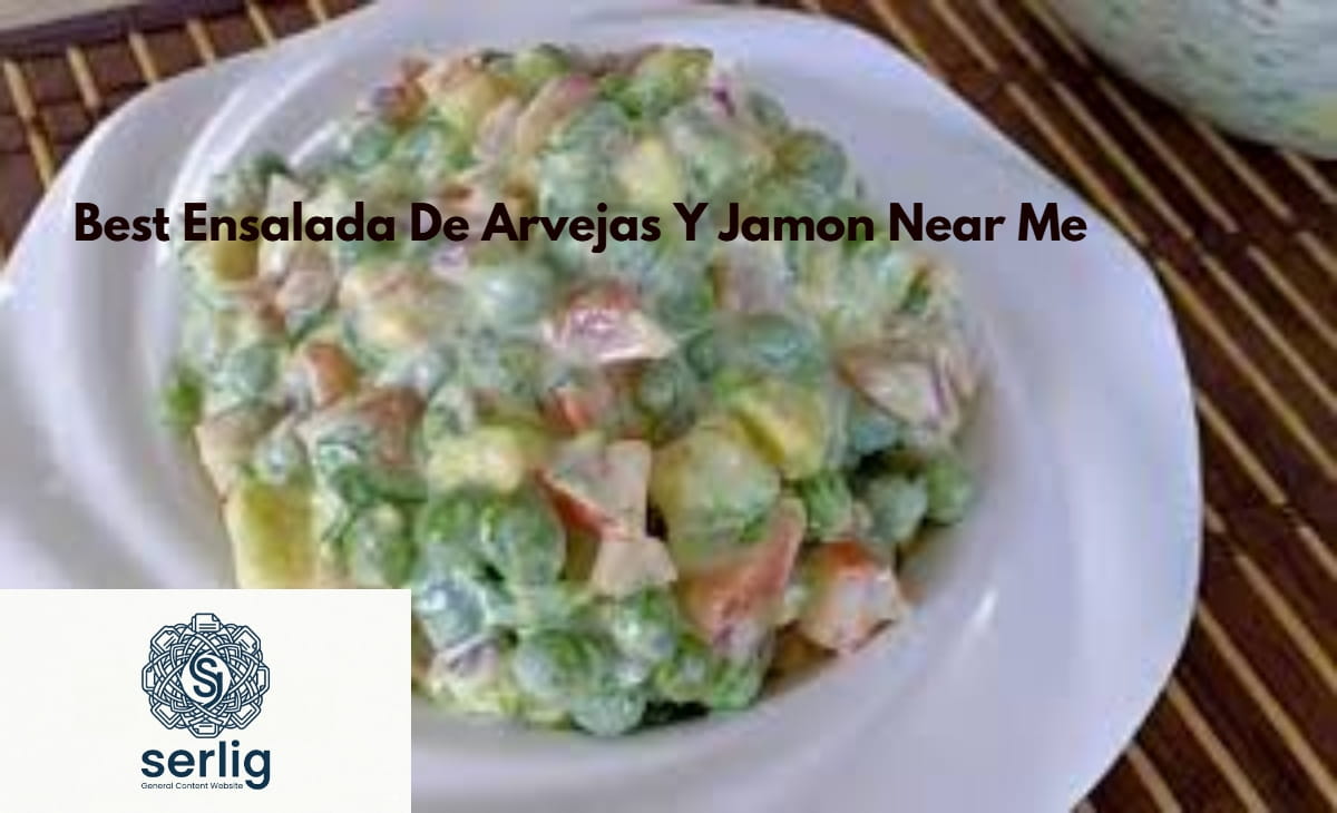 Best ensalada de arvejas y jamon in a white bowl with green peas, diced ham, eggs, and parsley garnish